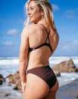 JAYD athlete Chloe wearing the high waist mid-coverage Tahiti Bikini Bottom in Cacao brown.