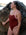 JAYD athlete Kim Doyle wearing the Airlie one piece in cinnamon with contrasting fairy floss shoulder straps, standing next to a rock and gazing off into the distance.