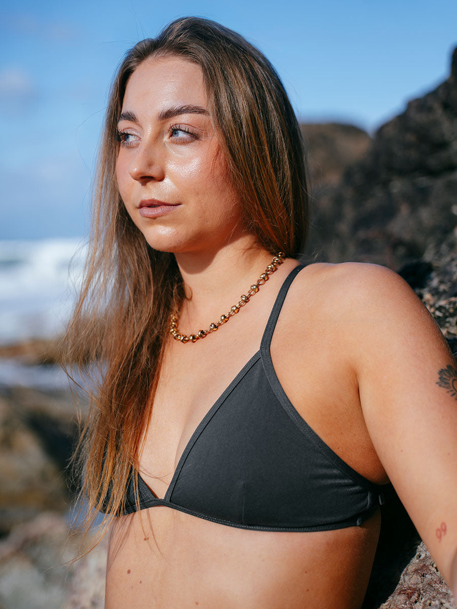 JAYD model Cass wearing the Kiama bikini swim top on the beach, a popular triangle style classic that is practical, stylish and functional.