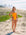 JAYD Swimwear model Hunter standing on a sand dune at the beach, wearing the Sunshine Tallow one piece swimsuit.